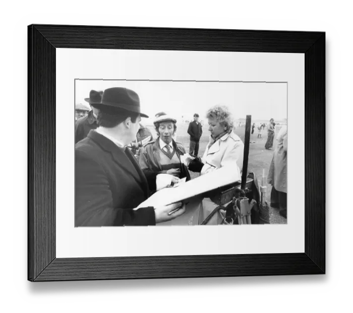 Framed Print : Cheltenham racecourse: Bookmaker Len da Costa from Birmingham pays out to a lucky punter Framed Print : Cheltenham racecourse: Bookmaker Len da Costa from Birmingham pays out to a lucky punter