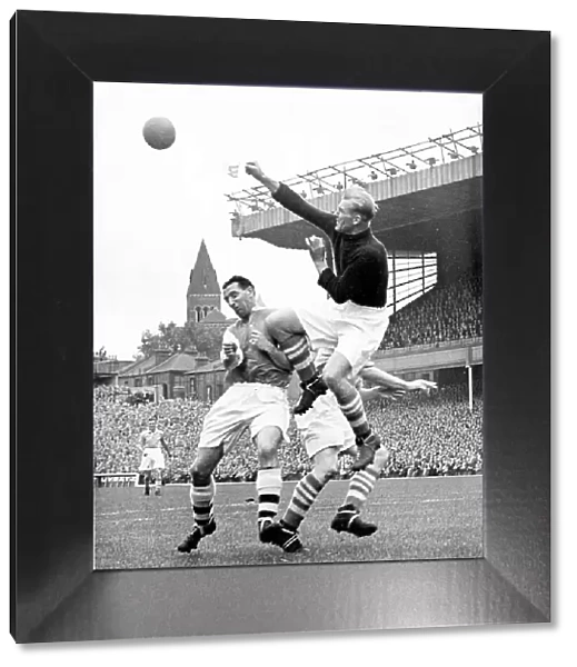 Bert Trautmann, Manchester City Goalkeeper clears the ball from Tommy Lawton of Arsenal