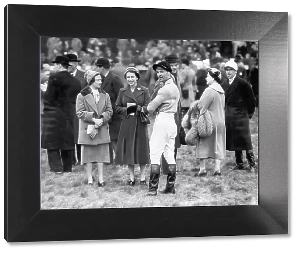 Queen Elizabeth II, Princess Margaret and the Queen Mother talk to Devon Loch's jockey, Dick Francis just before the race