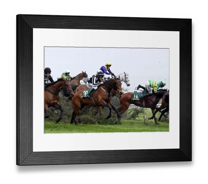 Framed Print : Horses clear the Chair jump on the second day at Aintree 2023. Rider Kevin Brogan fleetingly leaves his horse Phoenix Way Framed Print : Horses clear the Chair jump on the second day at Aintree 2023. Rider Kevin Brogan fleetingly leaves his horse Phoenix Way