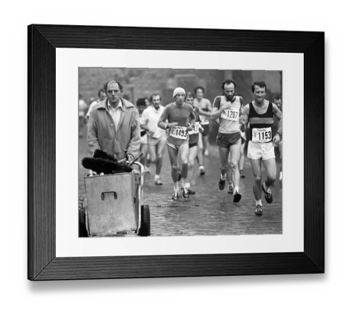 Framed Print : Competitors in the first London Marathon in March 1981 run past an unimpressed street cleaner Framed Print : Competitors in the first London Marathon in March 1981 run past an unimpressed street cleaner