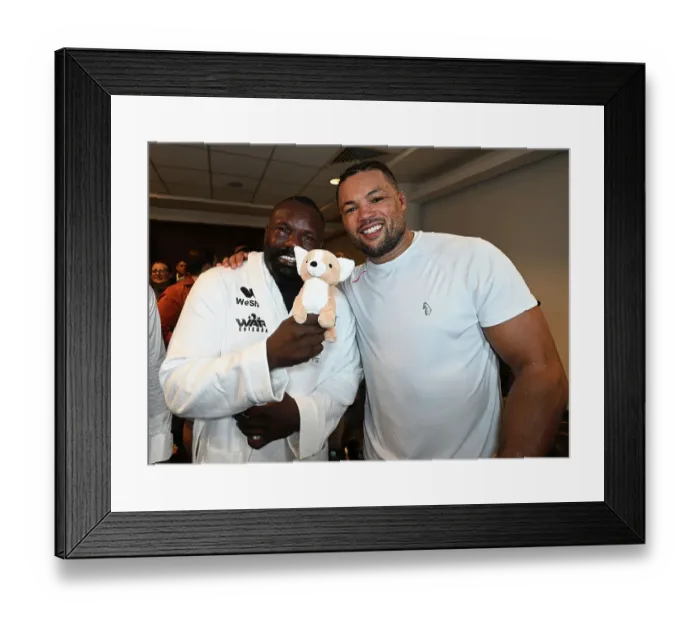 Framed Print : SoulofSport. Derek Chisora fight week behind the scenes 2024. Fight day at the 02, Derek and Joe Joyce embrace in Joe's changing room with a gift from Joe's mum