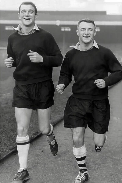 Arsenal players David Herd and Tommy Docherty training