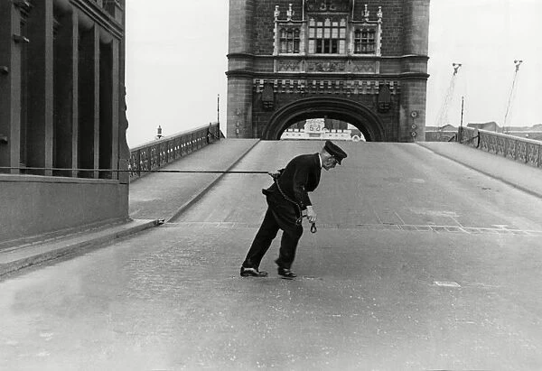 An attendant at London Tower Bridge closes the gate