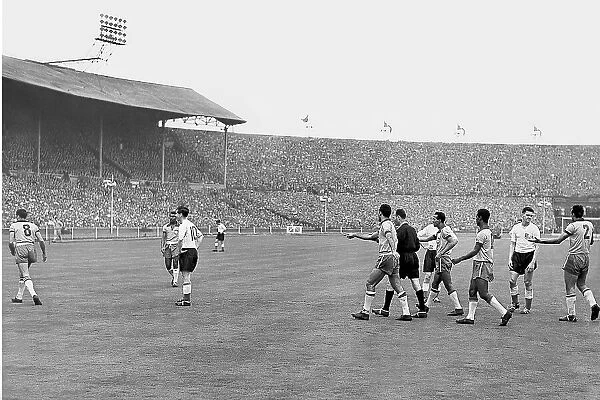 Brazil's number 8, Alvaro Valente, walks away with the ball followed by his team-mates and the referee after a penalty was awarded