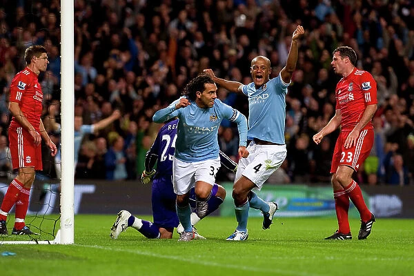 Carlos Tevez scores the second goal and Vincent Kompany celebrates Manchester City v Liverpool (3-0)