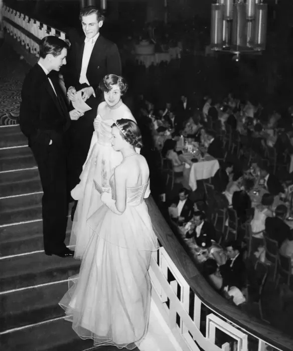 Framed Print : Debutantes and their escorts chat on the stairs at Queen Charlot