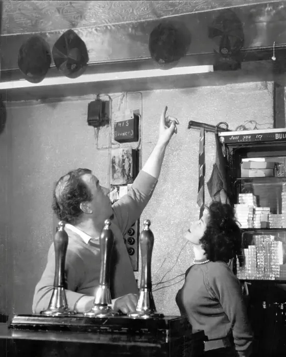 Framed Print : Dixie Dean shows off his England caps at the Dublin Packet pub in Chester, where he was landlord