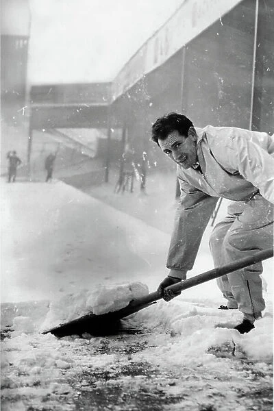 Emilio Aldecoa Birmingham City trainer clearing snow from pitch