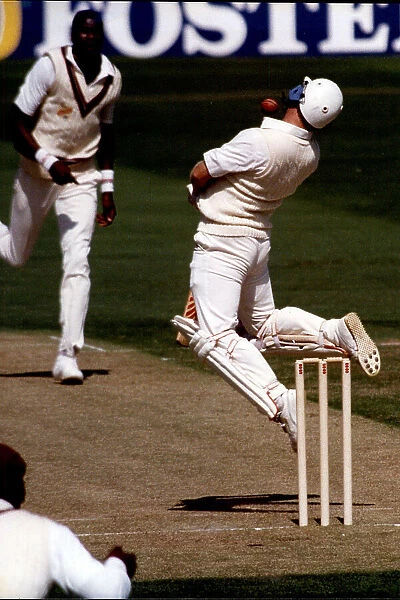 England's Hugh Morris avoids another bouncer from Curtly Ambrose