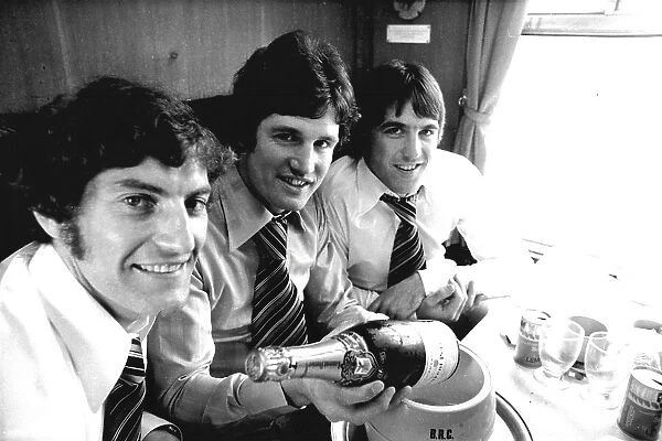Everton footballers celebrating with champagne. (L-R) Martin Dobson, Mick Lyons and Bob Latchford
