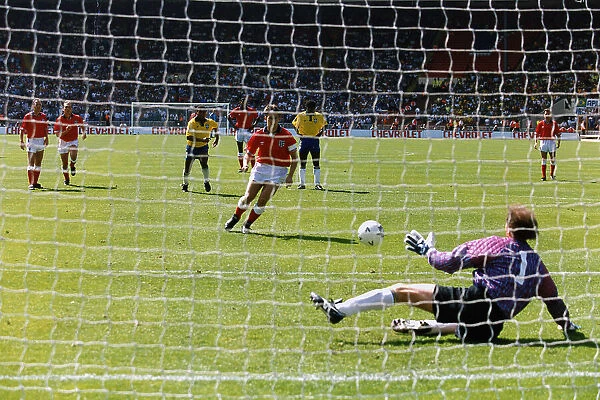 Footballer Gary Lineker misses a penalty during an international football match between England and Brazil. The goalkeeper is Carlos