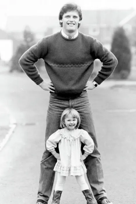 Framed Print : Gordon McQueen, former Manchester United footballer and television pundit is pictured with his daughter Hayley McQueen in 1983 Framed Print : Gordon McQueen, former Manchester United footballer and television pundit is pictured with his daughter Hayley McQueen in 1983