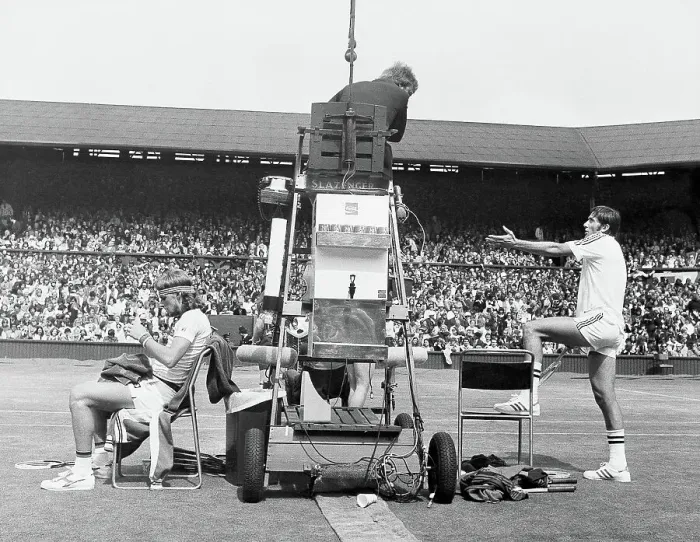 Framed Print : Ilie Nastase, argues with the umpire while Bjorn Borg quietly sits it out Framed Print : Ilie Nastase, argues with the umpire while Bjorn Borg quietly sits it out