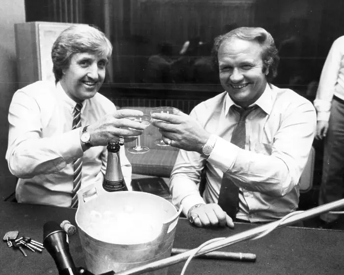 Framed Print : John Bond, manager of Manchester City FC drinks champagne with Ron Atkinson, manger of Manchester United, 1981 Framed Print : John Bond, manager of Manchester City FC drinks champagne with Ron Atkinson, manger of Manchester United, 1981