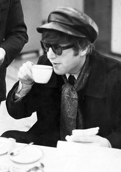 John Lennon has a cup of tea 1964