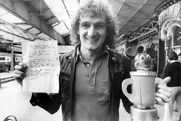Liverpool Footballer Phil Thompson with the Mickey Mouse Cup and letter presented to him before League Cup final by Everton fan