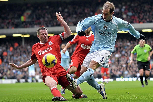 Liverpool's Jamie Carragher tackles Manchester City's Pablo Zabaleta