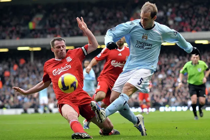 Framed Print : Liverpool's Jamie Carragher tackles Manchester City's Pablo Zabaleta