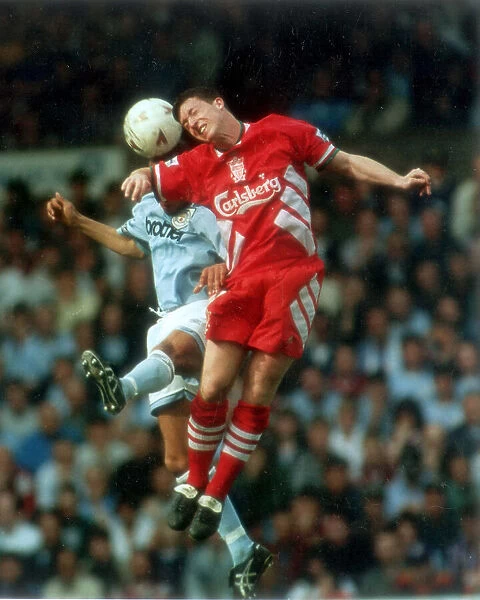 Liverpool's young star Robbie Fowler out jumps Keith Curle, of Manchester City