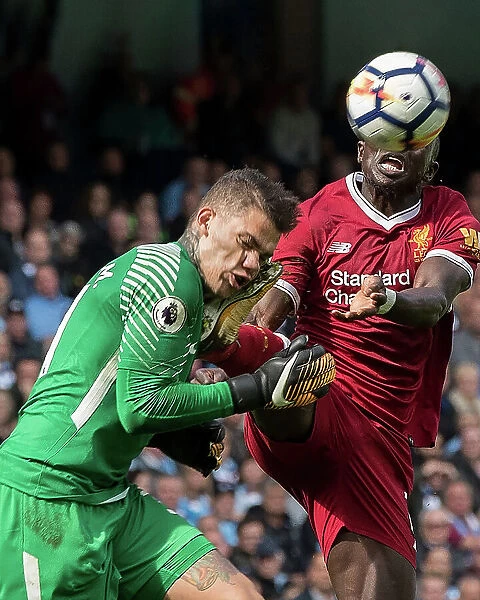 Manchester City goalkeeper Ederson clashes with Liverpool's Sadio Mane
