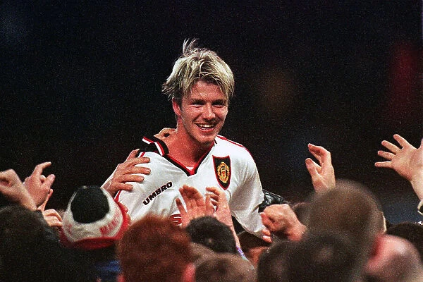 Manchester United's David Beckham is chaired off the Villa Park by fans after their extra-time win against Arsenal, in FA Cup semi-final replay 1999