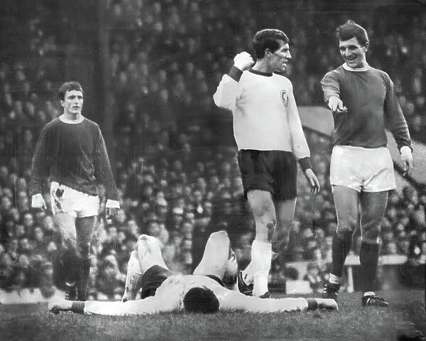 Manchester United's David Herd, as Willie Stevenson demonstrates how Liverpool captain Ron Yeats has been felled by George Best 1966