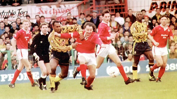 Mickey Thomas (red shirt) passes David Rowcastle of Arsenal for FA Cup 3rd round match; Wrexham v Arsenal (2-1), 1992