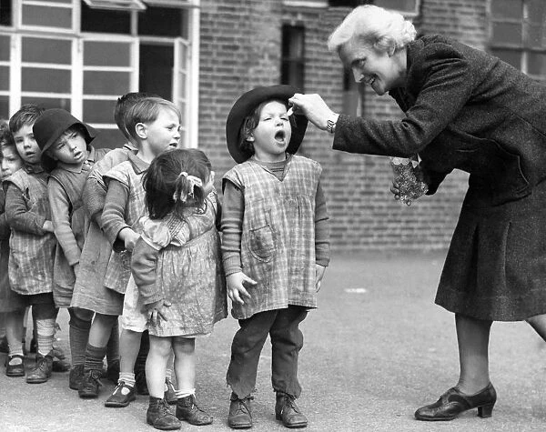 Open wide. Young children at the Greek Road Nursery Day School in Deptford