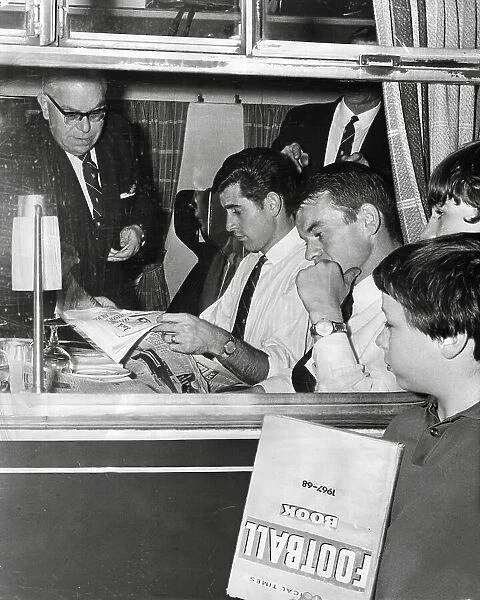 Peter Bonetti, Eddie McCreadie and Charles Pratt of Chelsea FC on train to Leeds as autograph hunters look on 1967