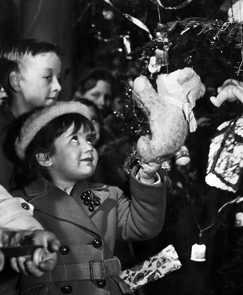 Putting presents on the tree, 1950s
