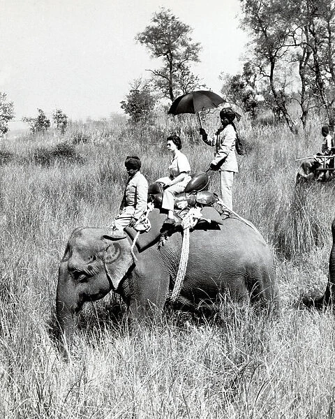 Queen Elizabeth II riding on an elephant in Nepal 1961