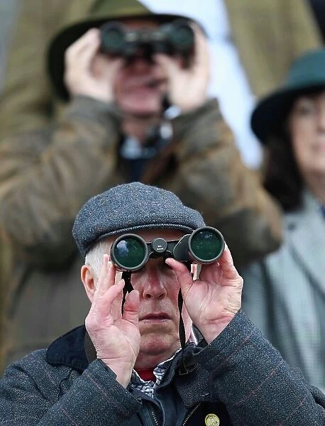Race goers with binoculars Grand National Festival at Aintree