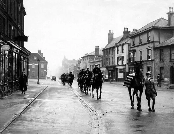 Racehorses pass through Newmarket on their way to the gallops in 1932