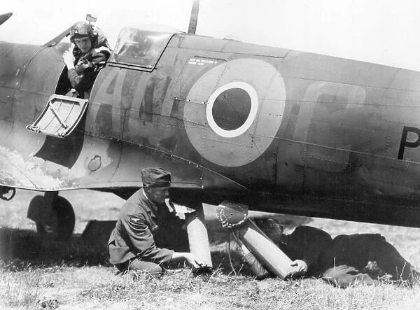 RAF ground crew loading air sea rescue equipment into the belly of a Spitfire