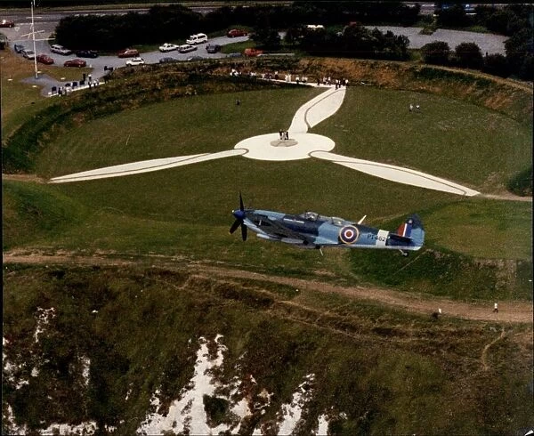 RAF Spitfire flies over the Battle of Britain Museum and Memorial at Capel-Le-Ferne in Dover, Kent
