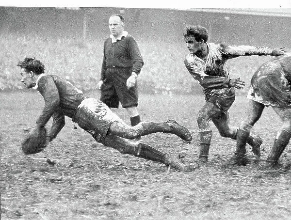 Rex Willis the Welsh scrum half, dives in getting the ball back to his partner Cliff Morgan