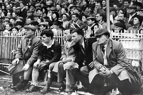 Rugby International 1961. Injured Cyril Davies sits on the touchline bench as Wales battle to victory