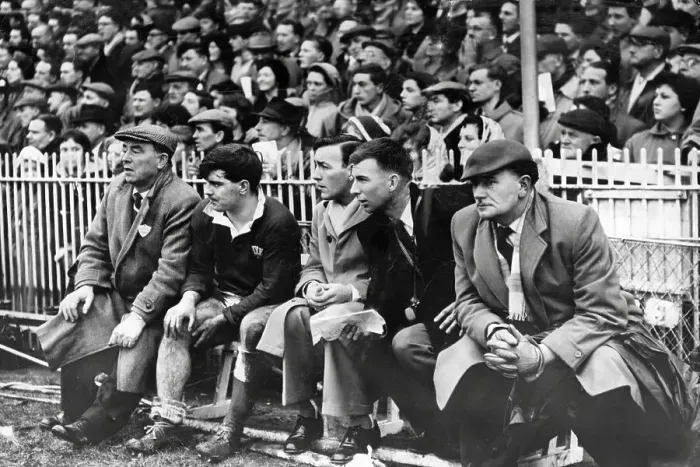Framed Print : Rugby International 1961. Injured Cyril Davies sits on the touchline bench as Wales battle to victory Framed Print : Rugby International 1961. Injured Cyril Davies sits on the touchline bench as Wales battle to victory