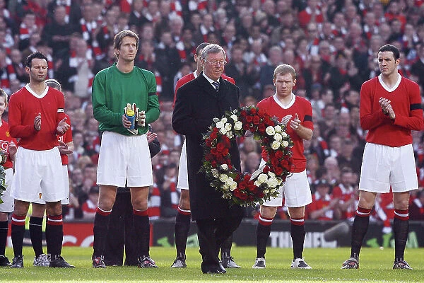 Sir Alex Ferguson holding a wreath to commemorate 50 years since the Munich Air disaster