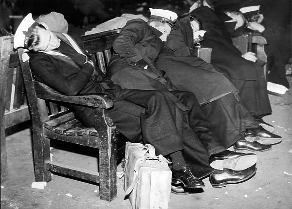 Sleeping sailors. Sailors sleeping on a bench at Waterloo train station