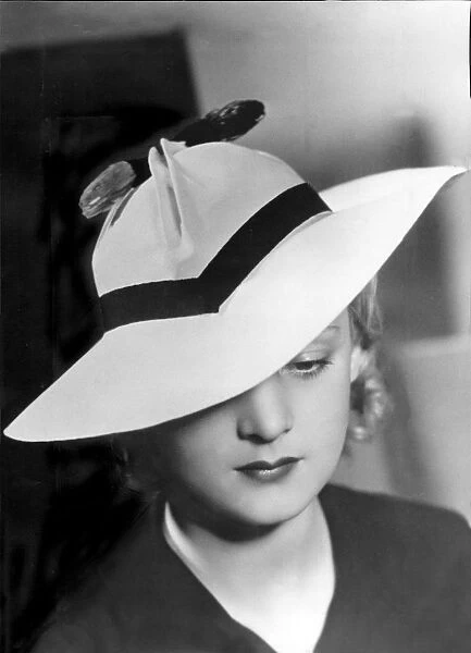 Smart 1930s hat. Model wearing straw hat with pleated crown, 1935