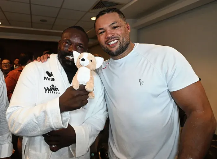 Framed Print : SoulofSport. Derek Chisora fight week behind the scenes 2024. Fight day at the 02, Derek and Joe Joyce embrace in Joe's changing room with a gift from Joe's mum