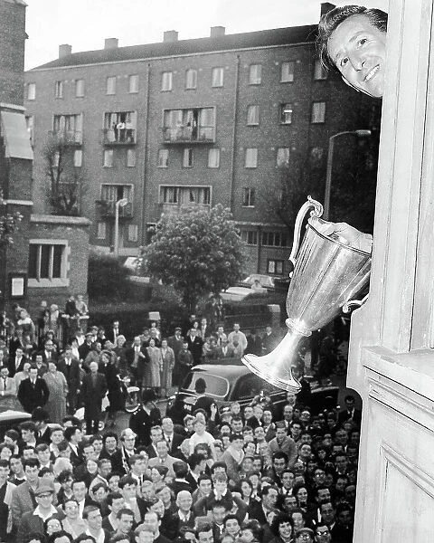 Tony Marchi waves the European Cup Winners Cup trophy from the Tottenham boardroom window 1963