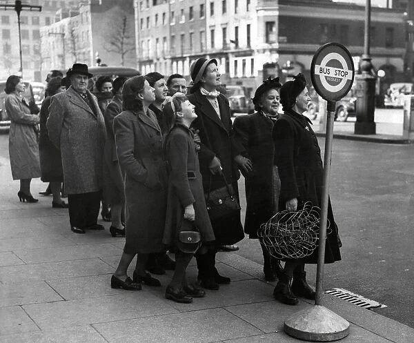 Waiting for the bus. Passengers queuing up at a request bus stop in Marylebone in London
