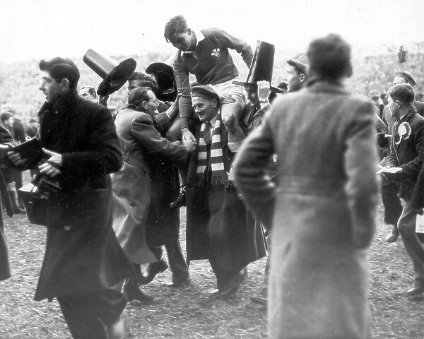 Wales rugby fans chairing the Welsh full back Terry Davis from the pitch after a 5 nations match 1953