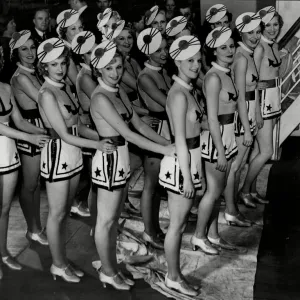 CB Cochran dancers in costume on stage for production of musical