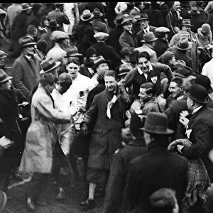 The crowd carry PT Murray to the pavillion after and Ireland win against England 1930