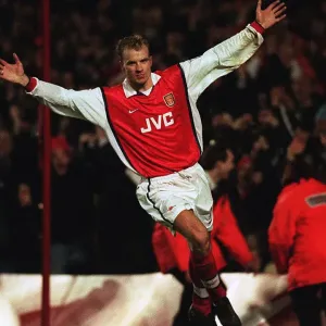 Dennis Bergkamp celebrates scoring for Arsenal