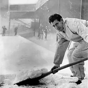 Emilio Aldecoa Birmingham City trainer clearing snow from pitch
